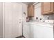Laundry room featuring washer, dryer, cabinets, and access door at 3301 S Goldfield Rd # 2034, Apache Junction, AZ 85119
