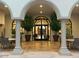 Welcoming lobby with arched doorway, tiled floor, ample seating, plants, and glass entry doors at 3301 S Goldfield Rd # 2034, Apache Junction, AZ 85119