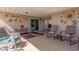 A covered patio with tile flooring, ample seating, and outdoor access at 3301 S Goldfield Rd # 2034, Apache Junction, AZ 85119