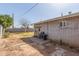 Backyard with an uneven concrete ground surface and a stone block perimeter, alongside a brick building at 3607 N 21St Ave, Phoenix, AZ 85015