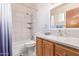Bathroom featuring a tiled shower and bath, vanity, toilet and a mirror at 3607 N 21St Ave, Phoenix, AZ 85015