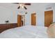 Spacious bedroom with white walls, ceiling fan, and wood doors at 3607 N 21St Ave, Phoenix, AZ 85015