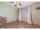 Neutral bedroom featuring hardwood floors, overhead fan with lighting and a sunlit window with stylish white curtains at 3607 N 21St Ave, Phoenix, AZ 85015