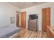 Bedroom with wood floors, large television, wooden doors and artwork at 3607 N 21St Ave, Phoenix, AZ 85015