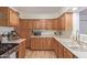 Well-lit kitchen with wood cabinets, light countertops and stainless steel appliances at 3607 N 21St Ave, Phoenix, AZ 85015