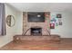 Bright living room featuring a brick fireplace with mantle and wood floors at 3607 N 21St Ave, Phoenix, AZ 85015