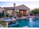 Gorgeous pool and spa with a covered patio and lush desert landscaping at 3634 E Sands Dr, Phoenix, AZ 85050