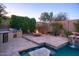 Lovely backyard featuring a BBQ area, cozy seating by a fire pit, and a luxurious swimming pool at 3634 E Sands Dr, Phoenix, AZ 85050
