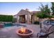 Beautiful backyard with a fire pit, BBQ area, outdoor seating, and a sparkling swimming pool at 3634 E Sands Dr, Phoenix, AZ 85050