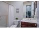 Cozy bathroom featuring a shower with a curtain, a single sink vanity, and neutral decor at 3634 E Sands Dr, Phoenix, AZ 85050