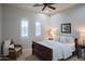 Bedroom offering a comfortable bed, a ceiling fan, and arched windows with shutters at 3634 E Sands Dr, Phoenix, AZ 85050