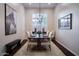 Formal dining area features a wood table, six chairs, decorative lighting and large windows at 3634 E Sands Dr, Phoenix, AZ 85050