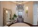 Inviting foyer with dark hardwood floors, light-colored walls, decorative mirror, and potted plants at 3634 E Sands Dr, Phoenix, AZ 85050