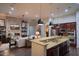 View of kitchen, granite countertop, and breakfast bar overlooking the inviting living space at 3634 E Sands Dr, Phoenix, AZ 85050