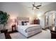 Well-lit bedroom offers a ceiling fan, neutral colors, and access to the Primary bathroom at 3634 E Sands Dr, Phoenix, AZ 85050