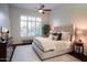 Bright bedroom features a large window, stylish ceiling fan, and neutral color palette at 3634 E Sands Dr, Phoenix, AZ 85050