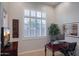 Bright home office with a dark wood desk, plantation shutters, and a neutral color palette at 3634 E Sands Dr, Phoenix, AZ 85050