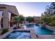 Beautiful backyard oasis featuring a pool, spa, outdoor kitchen, and fire pit at 3634 E Sands Dr, Phoenix, AZ 85050