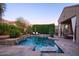 Stunning pool area with cascading waterfalls, lush landscaping, and relaxing lounge chairs at 3634 E Sands Dr, Phoenix, AZ 85050