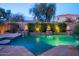 Swimming pool with tranquil waterfalls and fire bowls, set amongst professionally landscaped grounds at 3634 E Sands Dr, Phoenix, AZ 85050