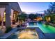 Stunning pool and spa with water features, outdoor kitchen, and covered patio at 3634 E Sands Dr, Phoenix, AZ 85050