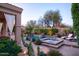 Resort-style backyard with a sparkling pool, hot tub, and cozy seating areas at 3634 E Sands Dr, Phoenix, AZ 85050