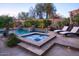 Inviting pool and spa area with lush landscaping and lounge chairs at 3634 E Sands Dr, Phoenix, AZ 85050