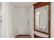 Cozy entryway featuring a decorative mirror and white paneled door at 3848 N 3Rd Ave # 1047, Phoenix, AZ 85013