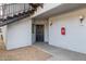 Apartment exterior with entry door, outdoor lighting, and stair access at 3848 N 3Rd Ave # 1047, Phoenix, AZ 85013