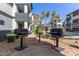 Outdoor grilling area with two grills and a table between multi-Gathering buildings at 3848 N 3Rd Ave # 1047, Phoenix, AZ 85013