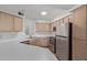 Well-lit kitchen featuring stainless steel appliances, a double sink and light wood cabinets at 3848 N 3Rd Ave # 1047, Phoenix, AZ 85013