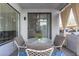 Relaxing outdoor patio with cushioned chairs and a glass top table on a blue area rug at 3848 N 3Rd Ave # 1047, Phoenix, AZ 85013