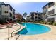 Beautiful community pool surrounded by apartments, lounge chairs, and manicured landscaping at 3848 N 3Rd Ave # 1047, Phoenix, AZ 85013