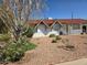 Single-story home featuring a red tile roof and low-maintenance desert landscaping at 3932 W Lawrence Ln, Phoenix, AZ 85051