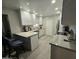Updated kitchen with a sleek design, marble countertops, and modern appliances at 3932 W Lawrence Ln, Phoenix, AZ 85051