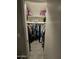 The walk-in closet has space for hanging and folded items with some overhead storage at 3932 W Lawrence Ln, Phoenix, AZ 85051