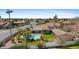 Aerial view of the home showcasing the backyard pool, landscaping, and neighborhood at 4066 E Grandview St, Mesa, AZ 85205