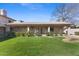 The backyard has a well manicured lawn and covered patio at 4066 E Grandview St, Mesa, AZ 85205