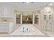 Gorgeous bathroom featuring a soaking tub with a large window, and a glass shower with tile surround at 4066 E Grandview St, Mesa, AZ 85205