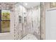 Bathroom with a glass shower featuring a marble tile surround and hexagonal tile shower floor at 4066 E Grandview St, Mesa, AZ 85205