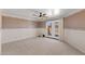 Spacious bedroom with neutral carpet, a ceiling fan, and a glass patio door at 4066 E Grandview St, Mesa, AZ 85205