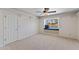 Carpeted bedroom with a ceiling fan, a window seat and a white interior door at 4066 E Grandview St, Mesa, AZ 85205