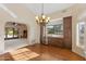 Elegant dining area featuring hardwood floors, a wine fridge, and ample cabinet space for storage at 4066 E Grandview St, Mesa, AZ 85205