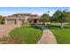 Inviting home with a well-manicured lawn, mature trees, and a spacious three-car garage at 4066 E Grandview St, Mesa, AZ 85205