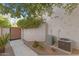 Exterior view of the home's air conditioning units and a walkway with an arched gate at 4066 E Grandview St, Mesa, AZ 85205