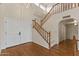 Home foyer featuring a staircase with wood railings, hardwood floors and a double door entry at 4066 E Grandview St, Mesa, AZ 85205