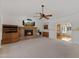 Open-concept living room featuring a brick fireplace, built-in shelving, and ample seating at 4066 E Grandview St, Mesa, AZ 85205