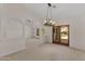 Bright living room with high ceilings, elegant chandelier, and a seamless flow to the outdoor patio at 4066 E Grandview St, Mesa, AZ 85205