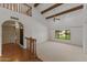 Bright living room with high ceilings, wooden beams, and staircase leading to the second floor at 4066 E Grandview St, Mesa, AZ 85205