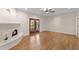 Bright living room with hardwood floors, a fireplace, ceiling fan and double french doors to the backyard at 4066 E Grandview St, Mesa, AZ 85205
